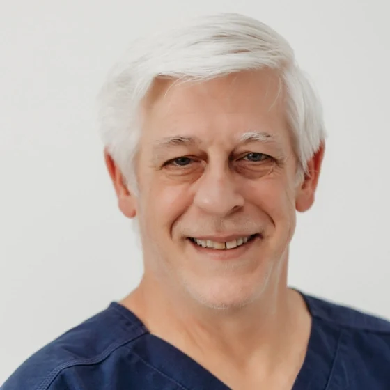 Dr. Mark Blankenship of Athens Dental Associates, in navy scrubs.