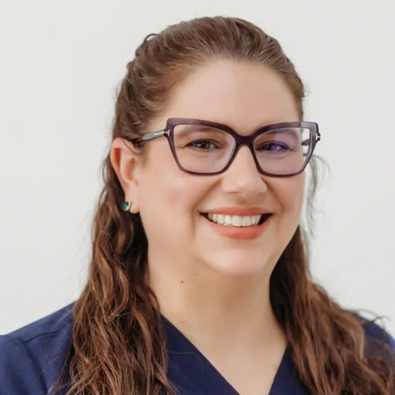 Dr. Rachel Clay of Athens Dental Associates, in navy scrubs.
